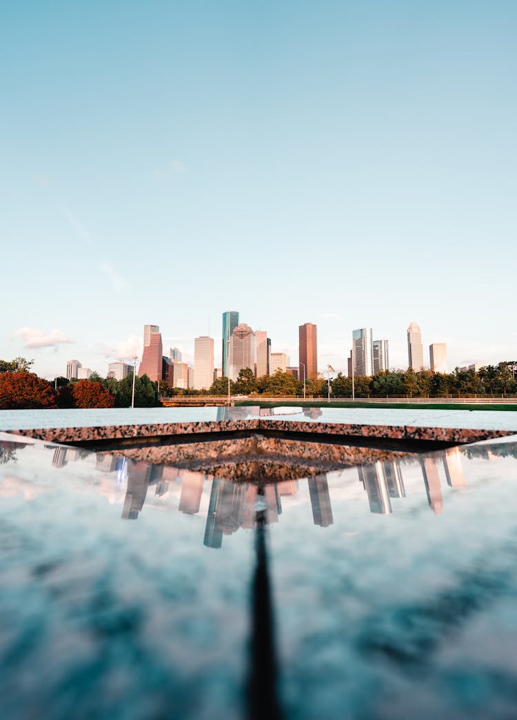 The Reflection Of The City Skyline On The Houston Police Officer's Memorial