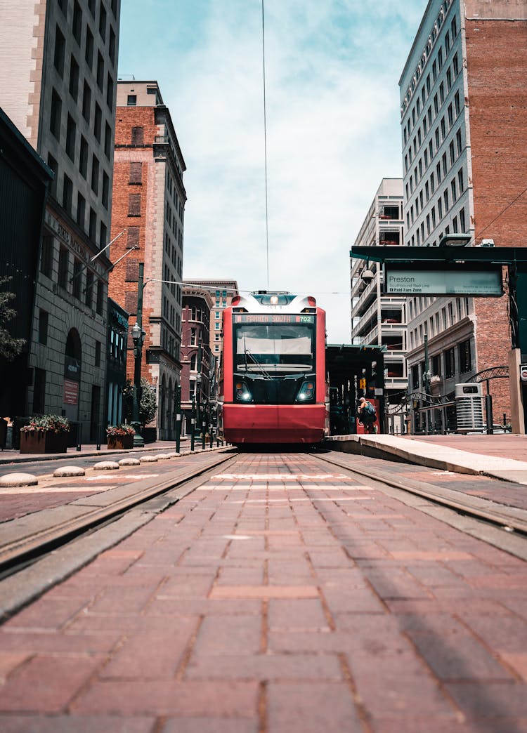 Red And Black Tram On Road