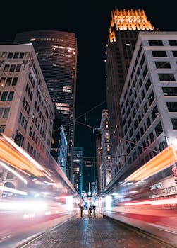 Vibrant night view of downtown Houston, TX with light trails and urban skyscrapers.