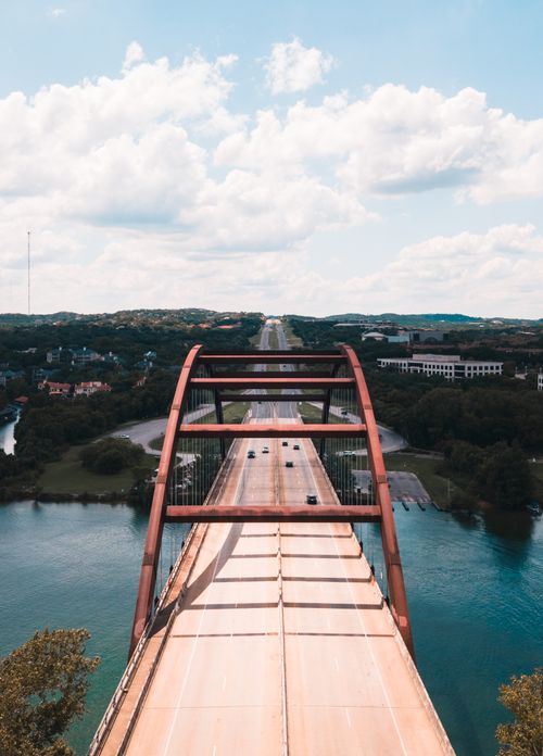 Free A stunning aerial shot of the iconic Pennybacker Bridge in Austin over the Colorado River on a sunny day. Stock Photo