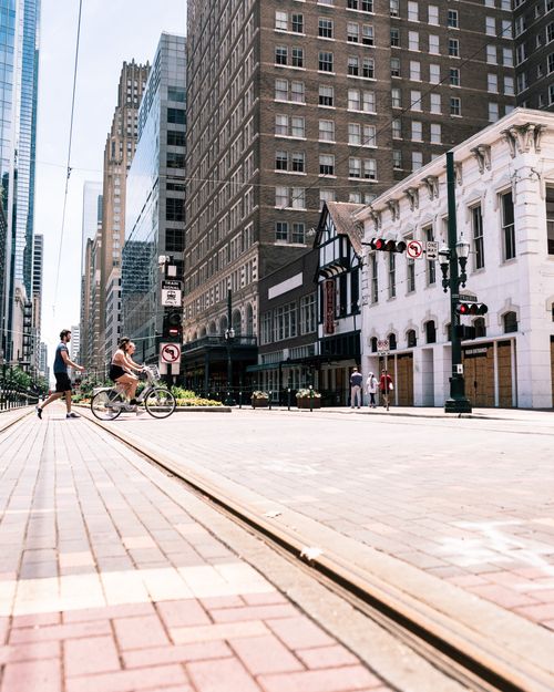 Free Vibrant street view in downtown Houston with pedestrians and cyclist under bright daylight. Stock Photo