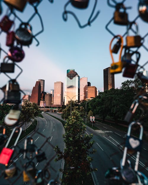 Roads and City Buildings through a Chain Link Fence 