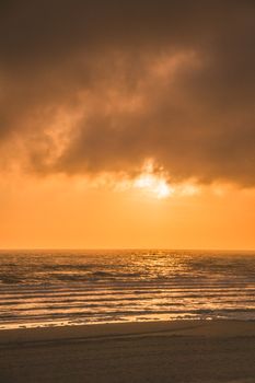 Golden sunset over Wissant Beach, creating a serene and warm oceanic view.