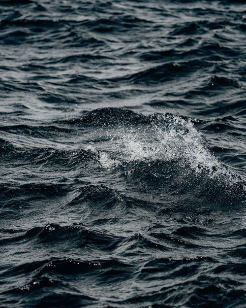 Free Close-up view of ocean waves with ripples and splashing water. Perfect for marine themes. Stock Photo