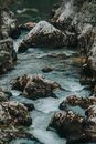 Black and Gray Rocks on Body of Water