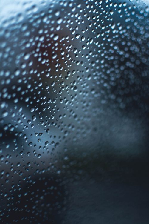 Free Close-up of raindrops on glass with a blue and turquoise abstract texture. Stock Photo