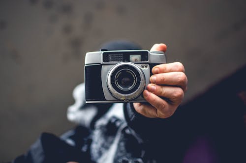 Free Person Holding Gray and Black Slr Camera Stock Photo