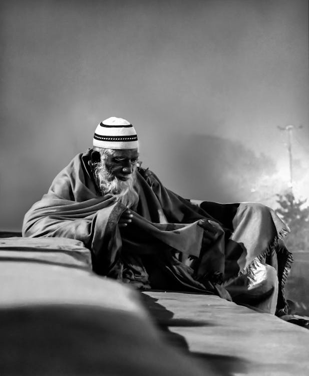 Grayscale Photo of Man With Taqiyah Cap