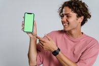 Man in Pink Crew Neck T-shirt Holding Blue Iphone Case
