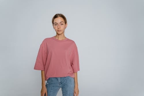 Woman in Red Crew Neck T-shirt and Blue Denim Jeans