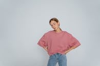 Woman in Pink Top and Denim Pants