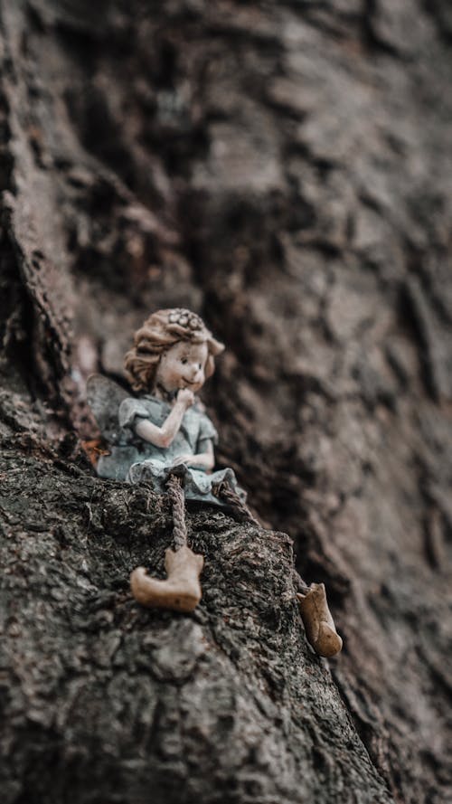 Free A Figurine on a Wooden Surface Stock Photo