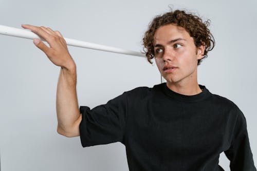 Man in Black Crew Neck T-shirt Holding White Stick