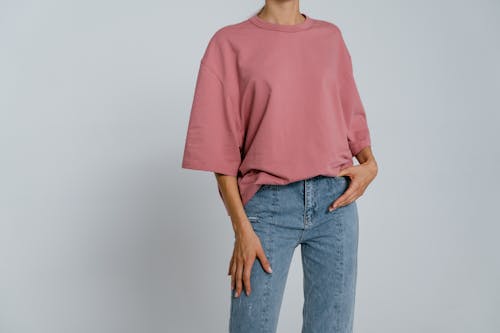 Woman in Pink Crew Neck T-shirt and Blue Denim Jeans