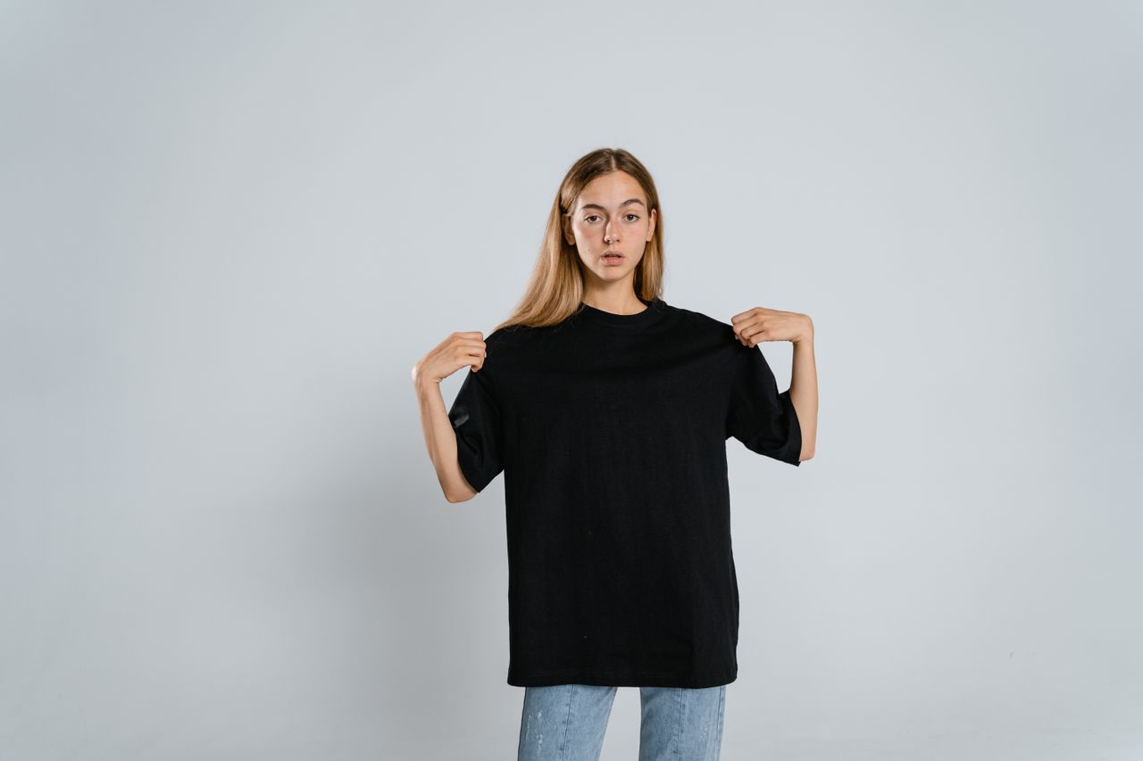 teenager in a black t shirt posing against a white background for a fa