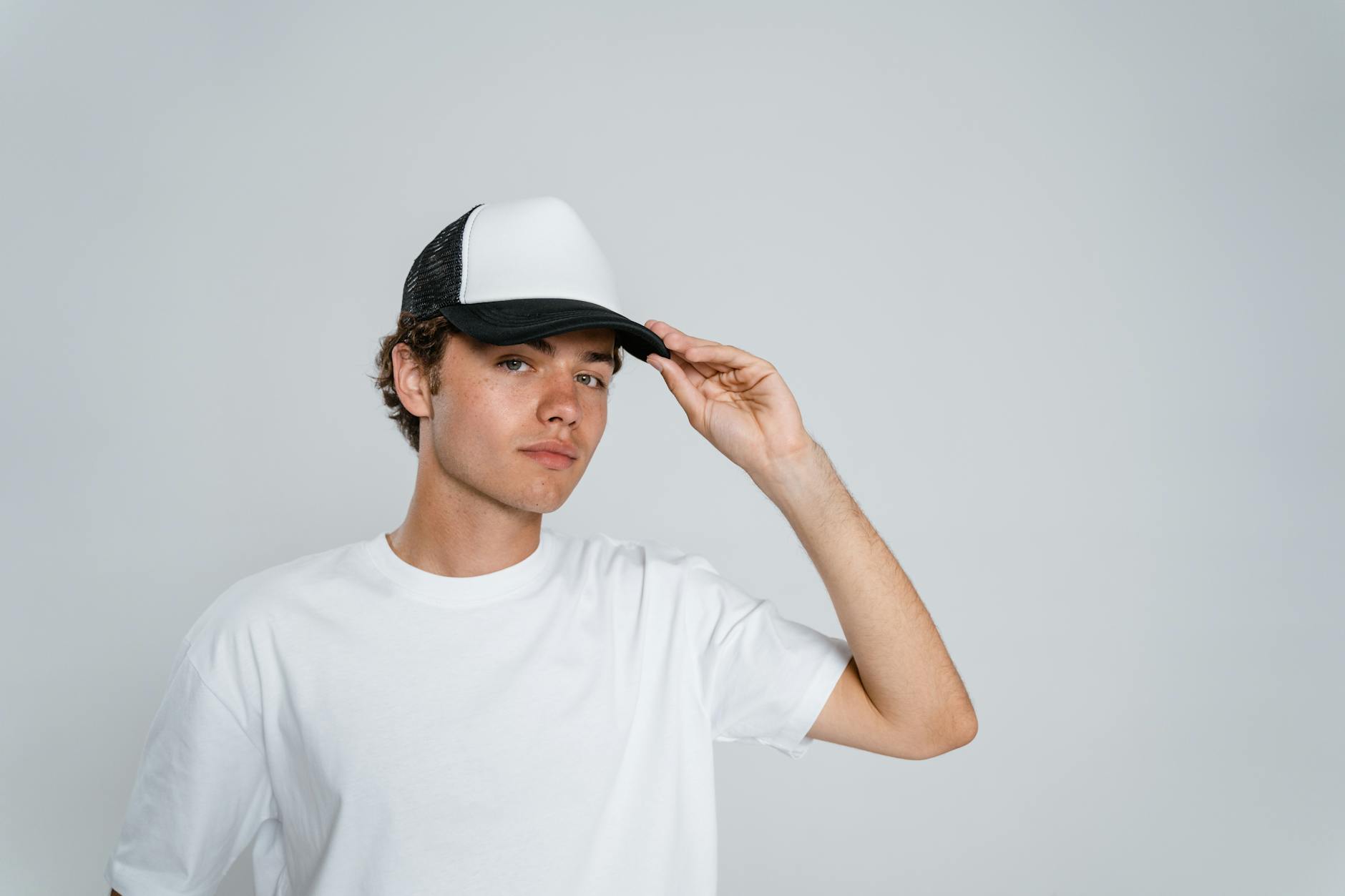 Man in White Crew Neck T-shirt Wearing White Fedora Hat