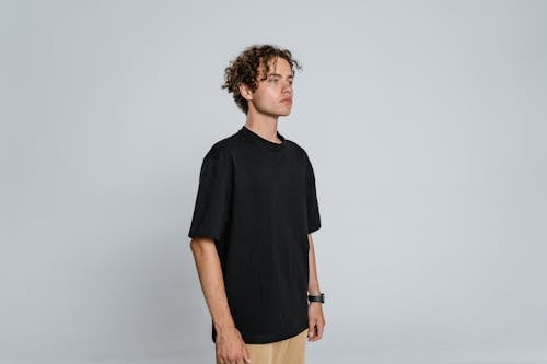 Man in Black Crew Neck T-shirt and Brown Shorts Standing · Free Stock Photo