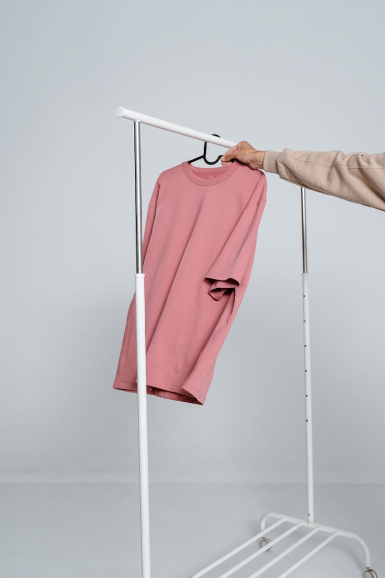 Hanging Of Pink Shirt On A Clothing Rack 