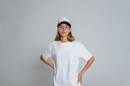 Woman in White Crew Neck T-shirt and White Cap
