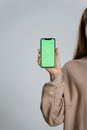 Woman in Gray Long Sleeve Shirt Holding Blue Iphone 5 C