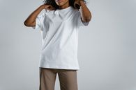Woman in White Polo Shirt and White Pants