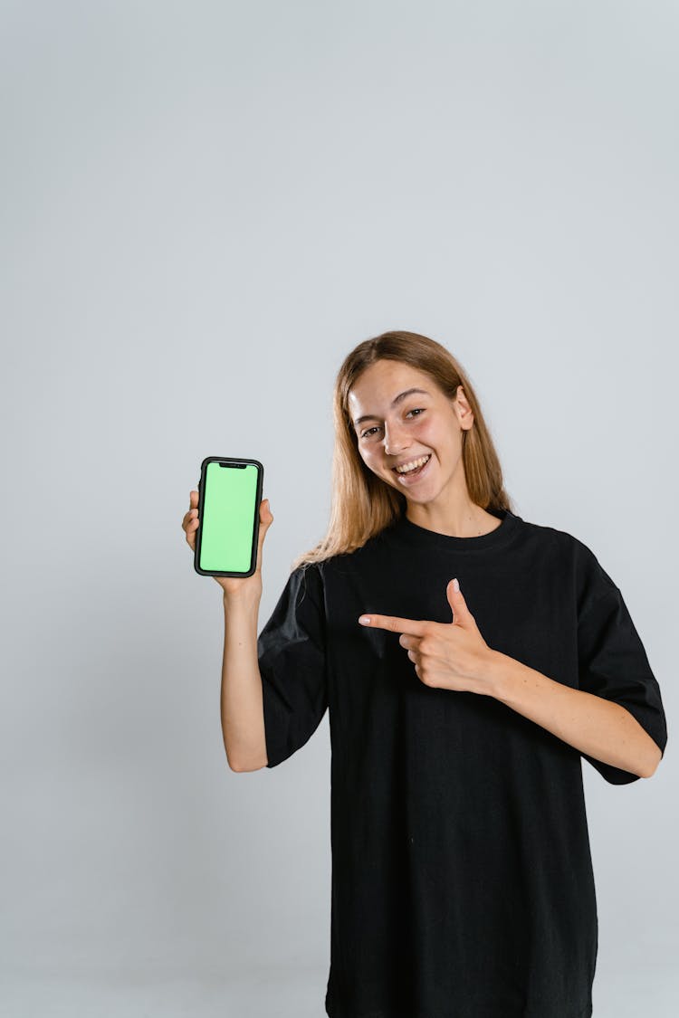 Woman In Black Crew Neck Shirt Holding A Cellphone