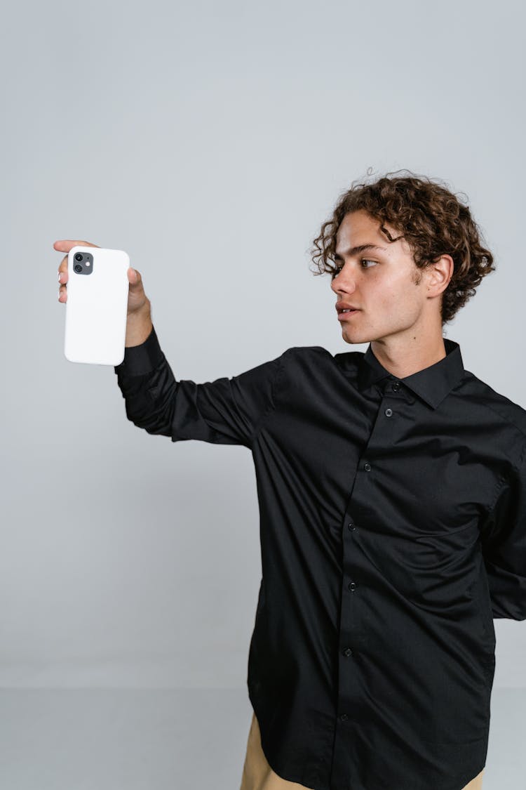 Man In Black Dress Shirt Holding White Ceramic Mug