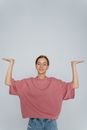 Woman in Red Crew Neck T-shirt Raising Her Right Hand