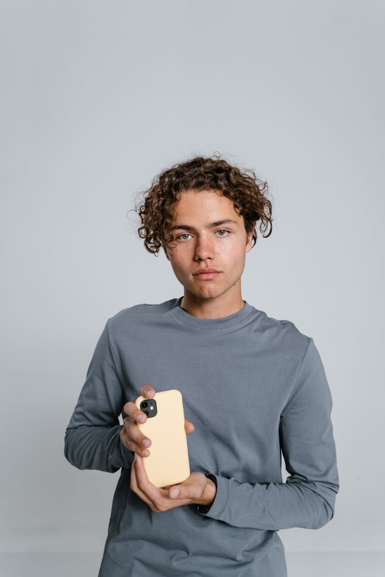 Man In Gray Crew Neck Long Sleeve Shirt Holding White Iphone 5 C