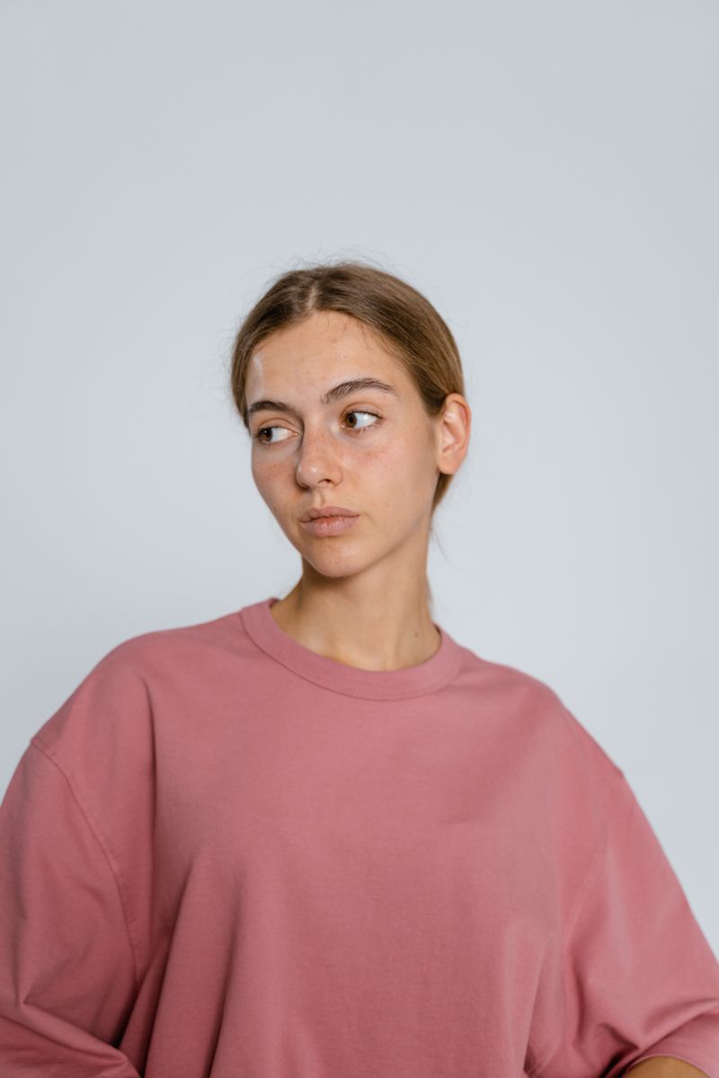 Woman wearing a dusty pink crew sweatshirt