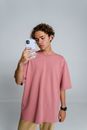 Man in Pink Crew Neck T-shirt Holding Silver Iphone 6