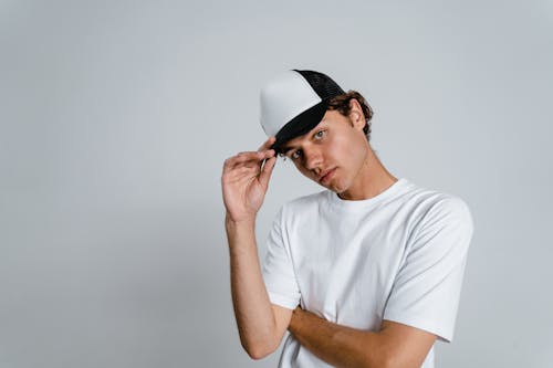 Man in White Crew Neck T-shirt Wearing White Cap