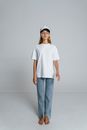 Woman in White Crew Neck T-shirt and Blue Denim Jeans