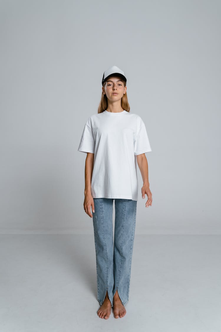 Woman In White Crew Neck T-shirt And Blue Denim Jeans