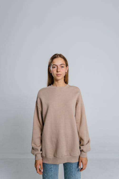 Woman in Brown Long Sleeve Shirt in White Background