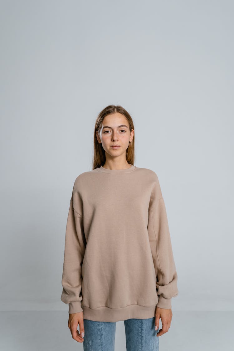 Woman In Brown Long Sleeve Shirt In White Background