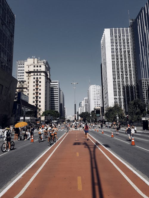 People on Road between High-rise Buildings 