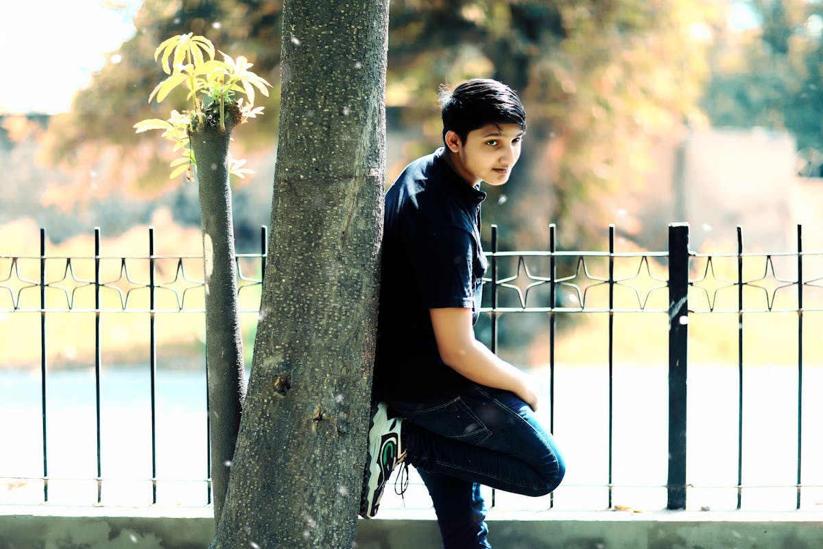 A brightly colored blue-green viper resting on a branch