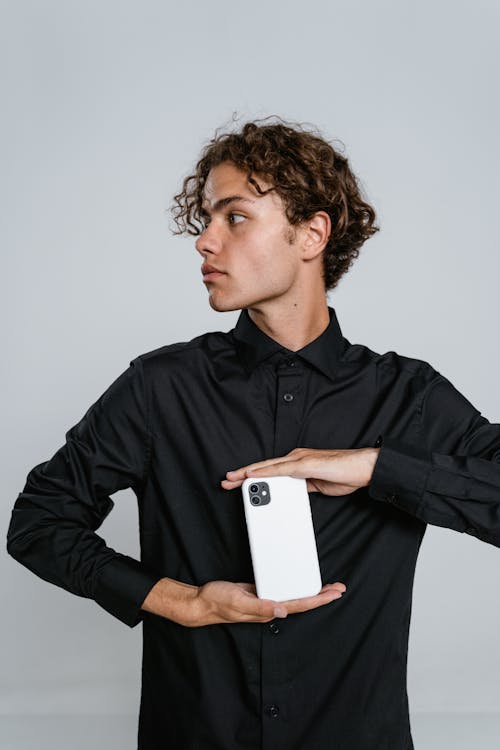 Man in Black Dress Shirt Holding White Smartphone