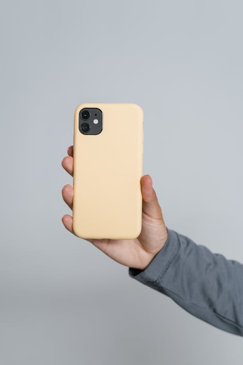 Free Person Holding Yellow Iphone Case Stock Photo