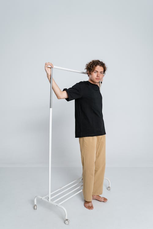 Free Man in Black Sweater and Brown Pants Holding White Stick Stock Photo
