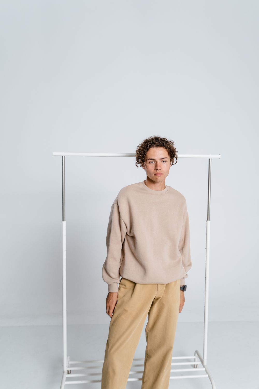 A model wearing a relaxed top and wide trousers against a plain studio backdrop. Photo by MART PRODUCTION on Pexels.