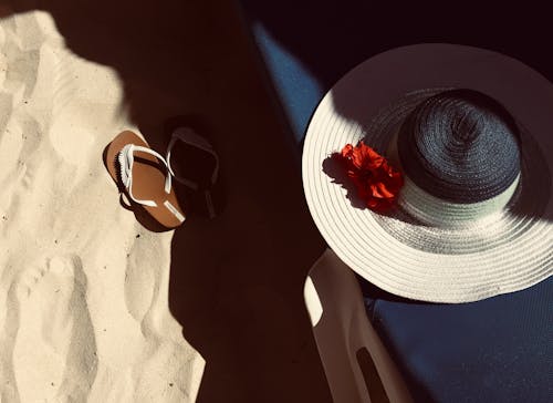 White and Black Hat on Blue Surface