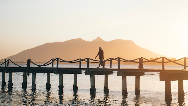 Person Walking On A Jetty 