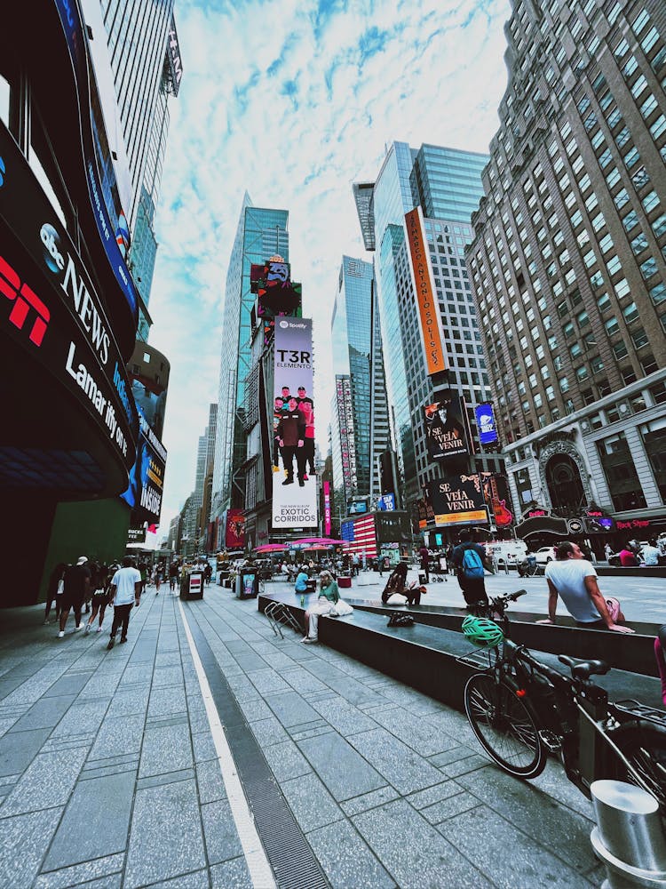 People Sitting On The Benches In Time Square