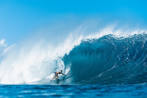 Person Surfing on Sea Waves