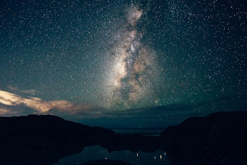 Silhouette of Mountain Under Starry Night