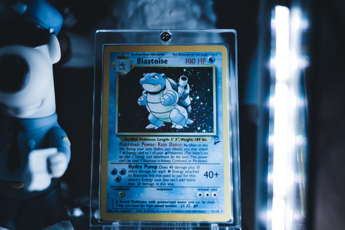 Blastoise Pokémon card in a protective case on a display shelf