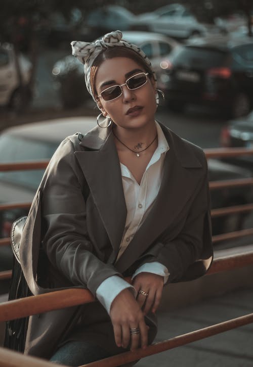 Free A Woman in Gray Coat Wearing Black Sunglasses Stock Photo