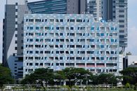 Contemporary high-rise building featuring a geometric facade with blue and white patterns.